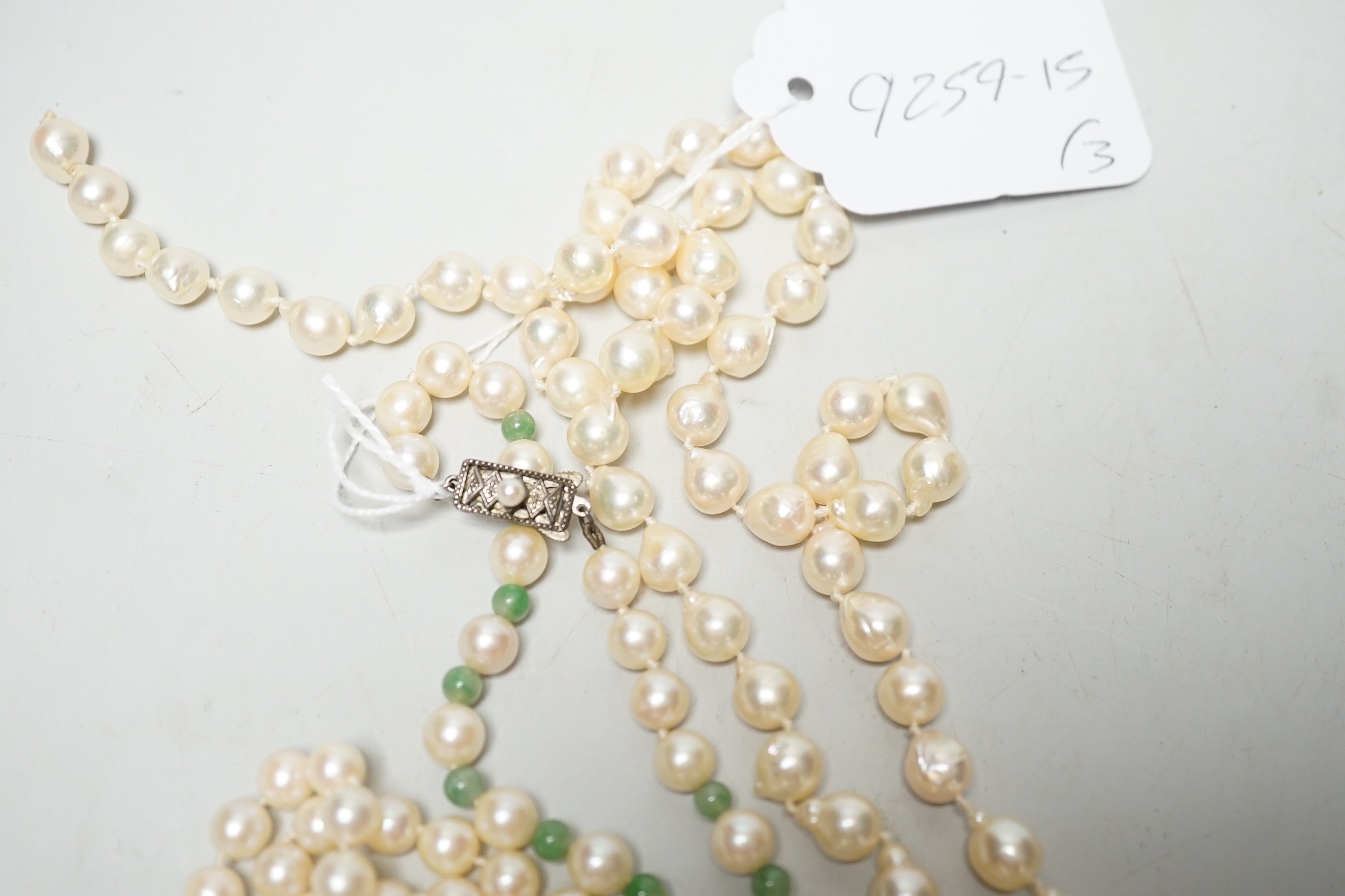 A Mikimoto single strand cultured pearl and green quartz? bead necklace, with white metal and cultured pearl set clasp, 55cm and two other cultured pearl necklaces.